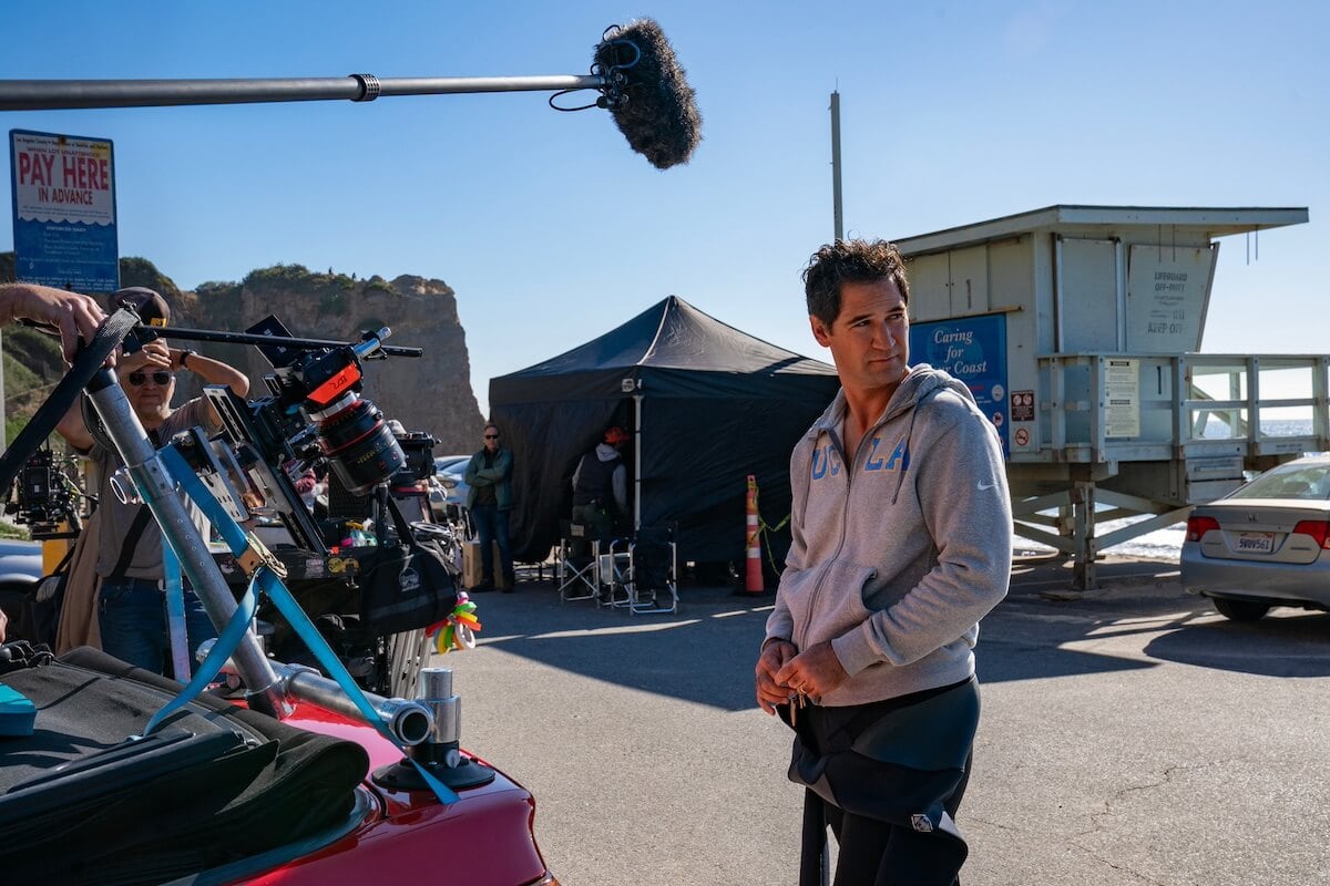 Manuel Garcia-Rulfo wearing a wetsuit and sweatshirt while filming 'The Lincoln Lawyer' Season 3