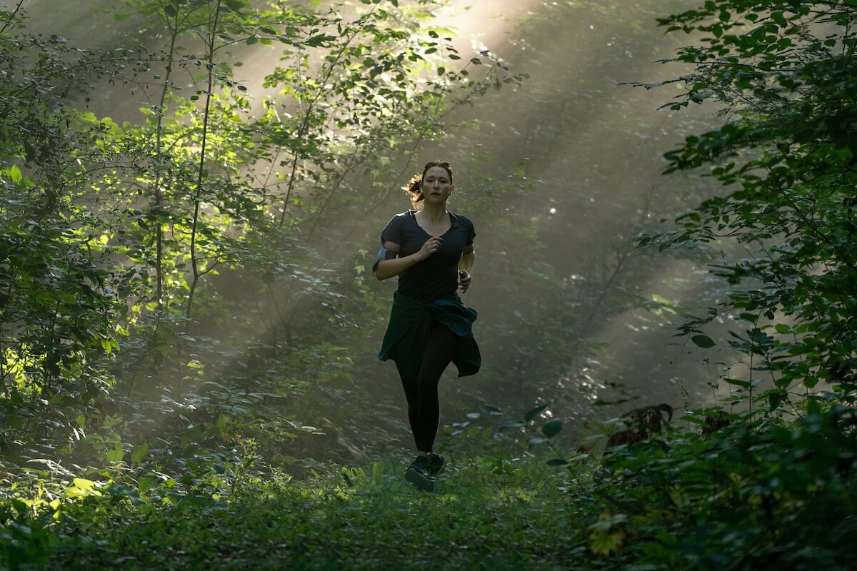 Kat running through the woods in 'The Way Home' Season 2