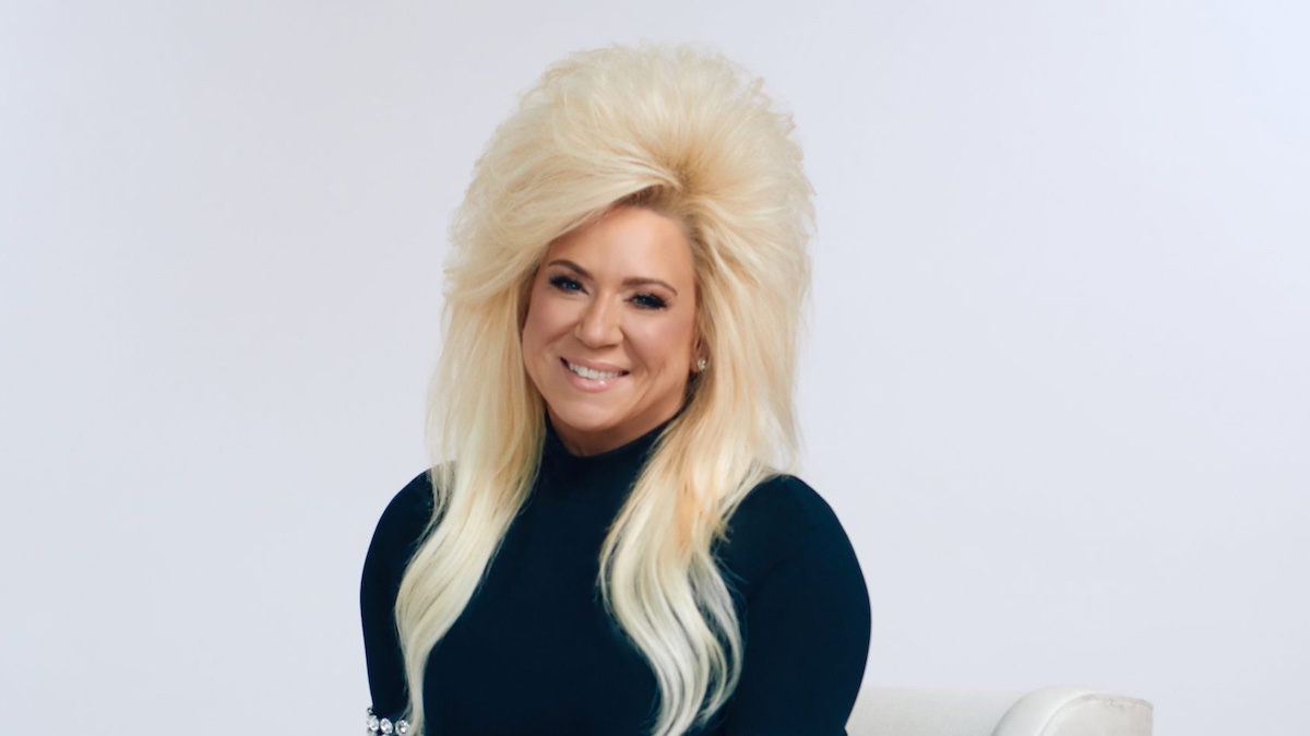 Portrait of Theresa Caputo of 'Raising Spritis' in a black top on a white background