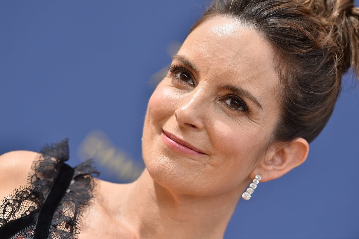 Tina Fey posing in a dress at the Emmys.