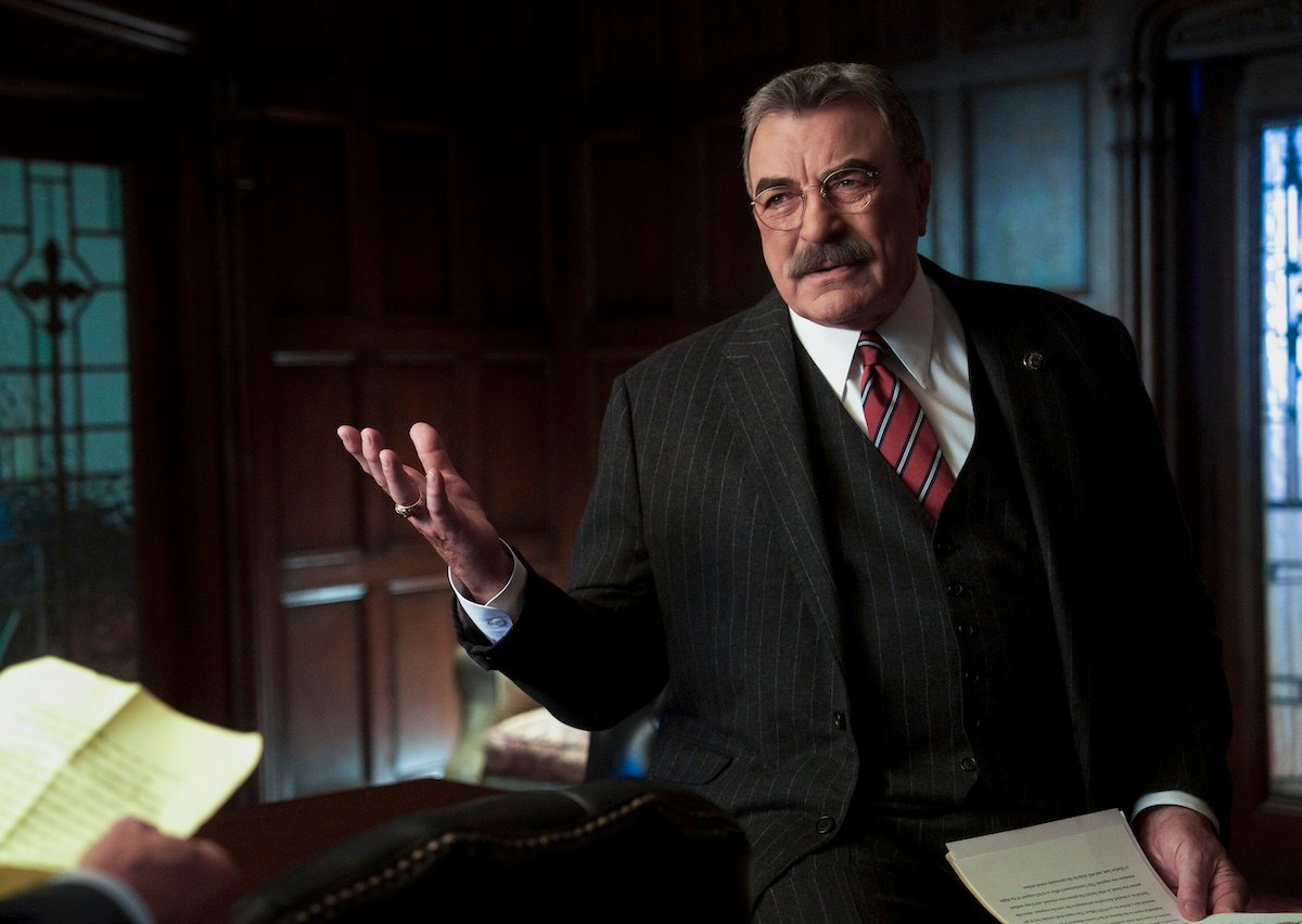 Tom Selleck in a suit and gesturing with his hands in 'Blue Bloods' Season 14