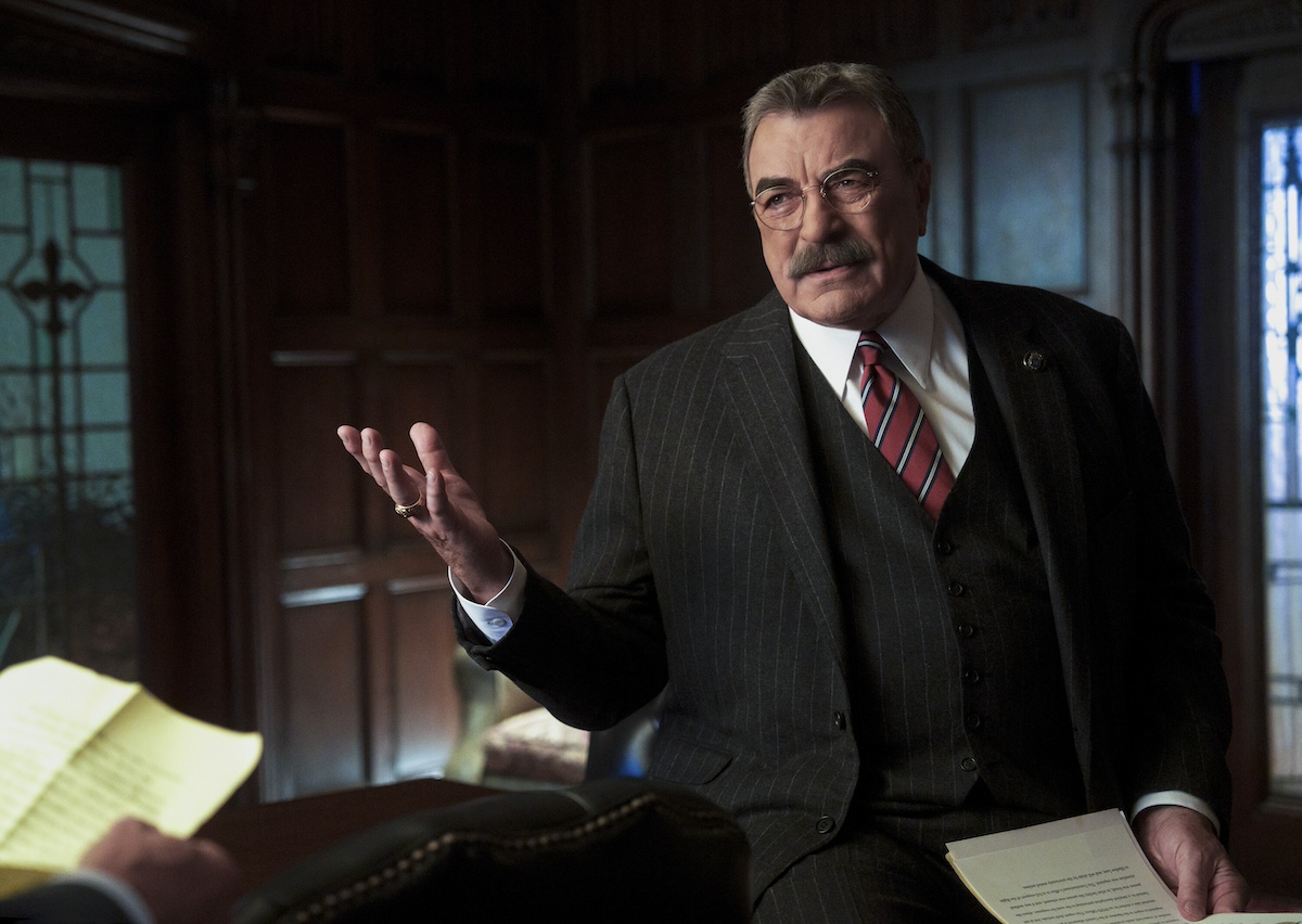 Tom Selleck in a suit and gesturing with his hands in 'Blue Bloods' Season 14