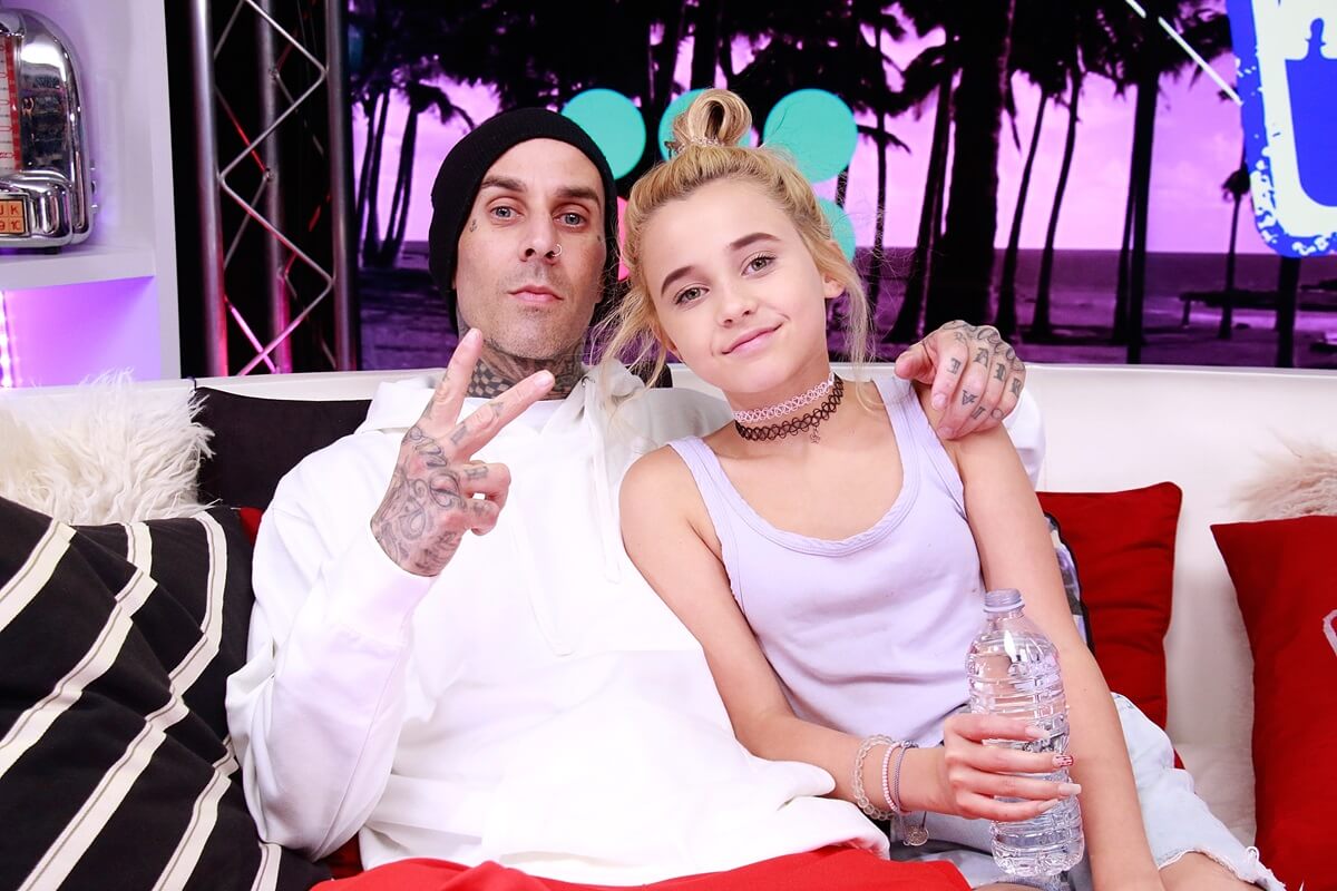 ) Travis Barker and Alabama Barker visits the Young Hollywood Studio, posing for the camera.