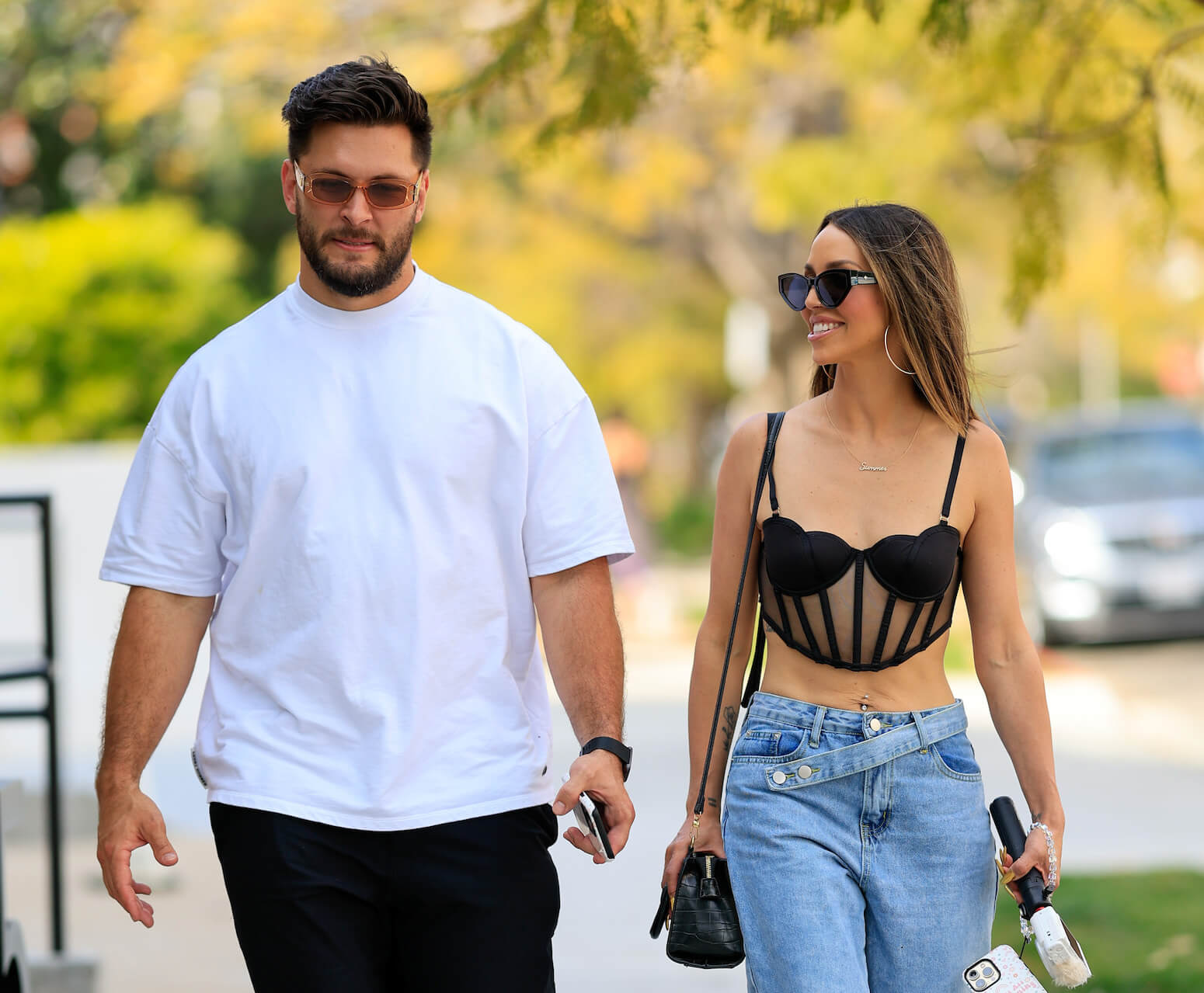 'Vanderpump Rules' star Scheana Shay walking next to her husband, Brock Davies, outdoors