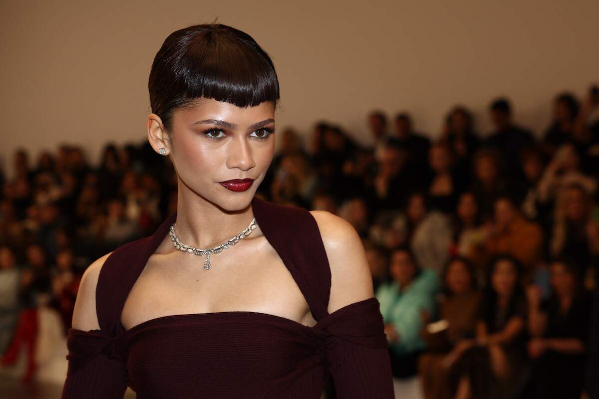 Zendaya, wearing a crimson dress and diamonds, poses for photos before the Fendi Women's Haute-Couture Spring/Summer 2024 show
