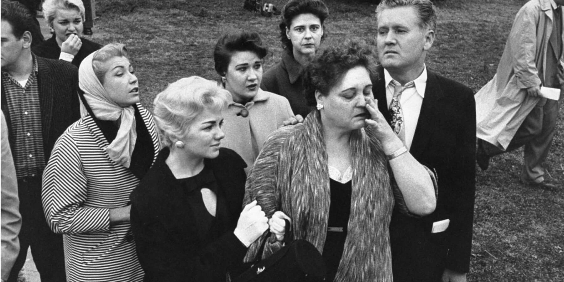 Anita Wood holds onto Gladys Presley with Vernon Presley as they bid Elvis Presley goodbye as he left for Army basic training.