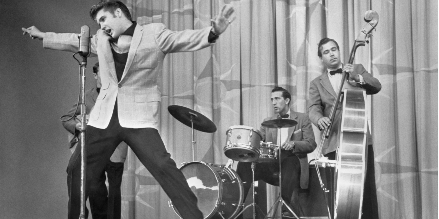 Elvis Presley dancing on stage in the late 1950s.