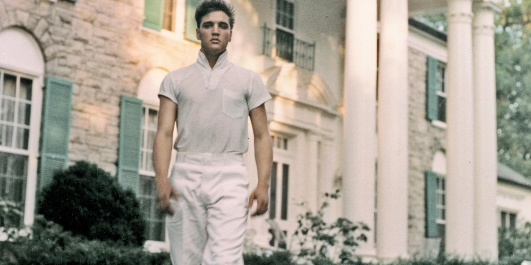 Elvis Presley poses outside of his beloved Graceland home, where his birthday is celebrated every year.