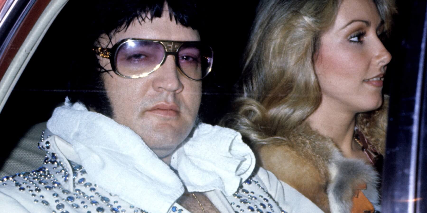 Elvis Presley and Linda Thompson together in a car in a photo taken in 1976.