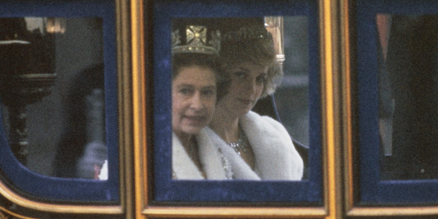 Queen Elizabeth and Princess Diana ride in a coach on the way to the state opening of Parliament.