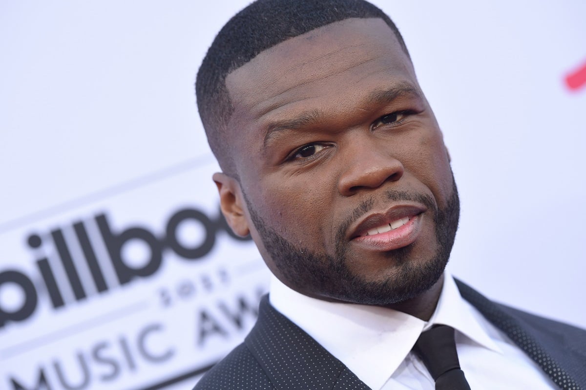 50 Cent posing in a suit at the 2015 Billboard Music Awards at MGM Garden Arena.