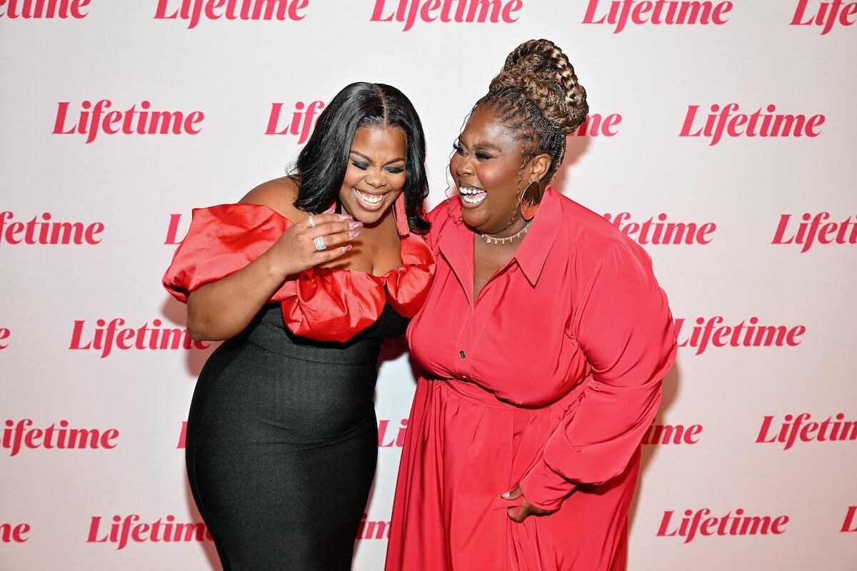 Amber Riley and Raven Goodwin laughing on the red carpet at the premiere of 'Single Black Female 2'