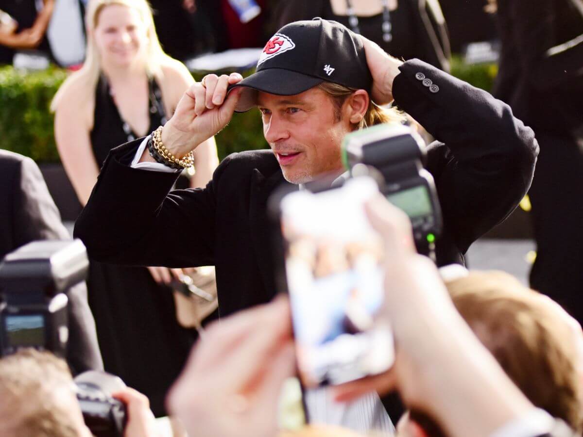 Brad Pitt puts on a Kansas City Chiefs hat at the 26th annual Screen Actors Guild Awards