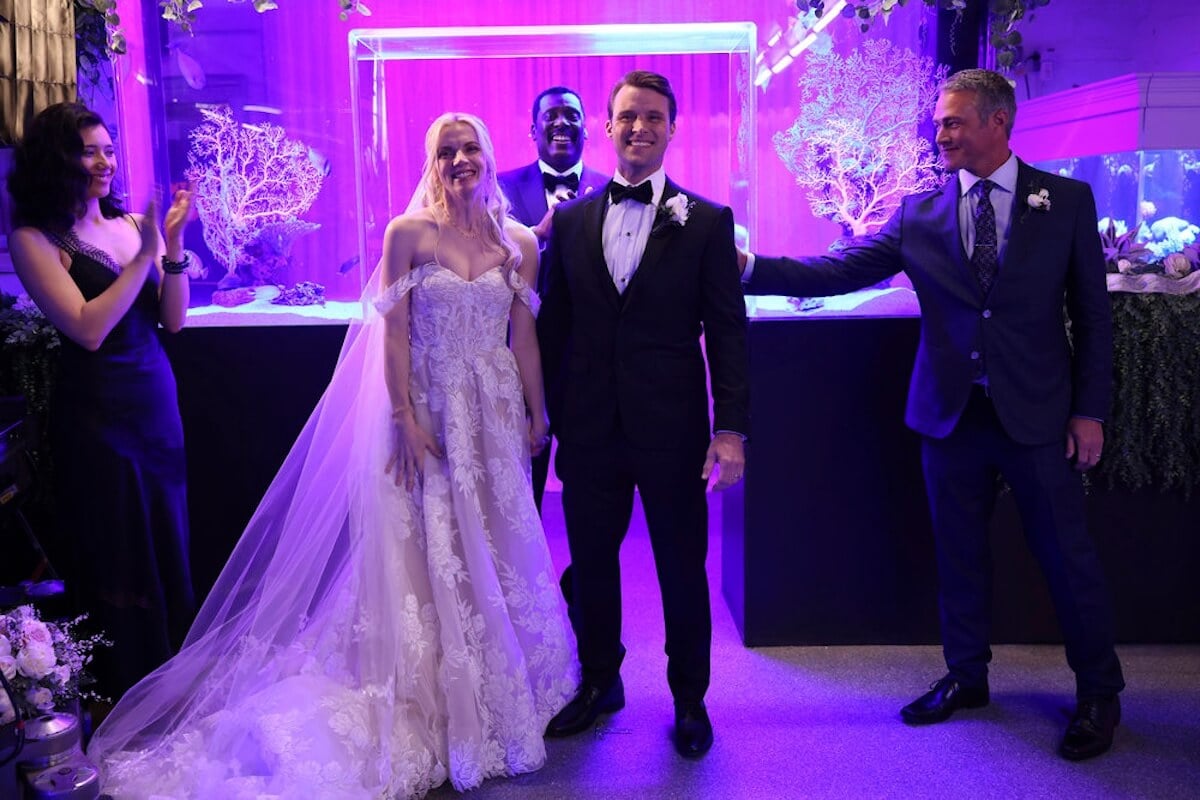 Sylvie Brett and Matt Casey holding hands at their wedding ceremony in 'Chicago Fire'