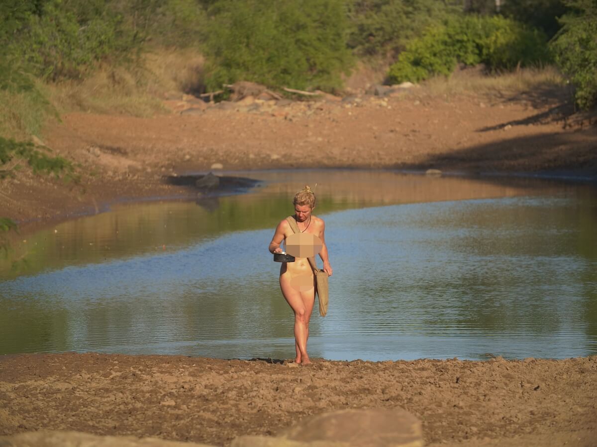 Britt Laidlaw of 'Naked and Afraid' standing in front of a pool of water