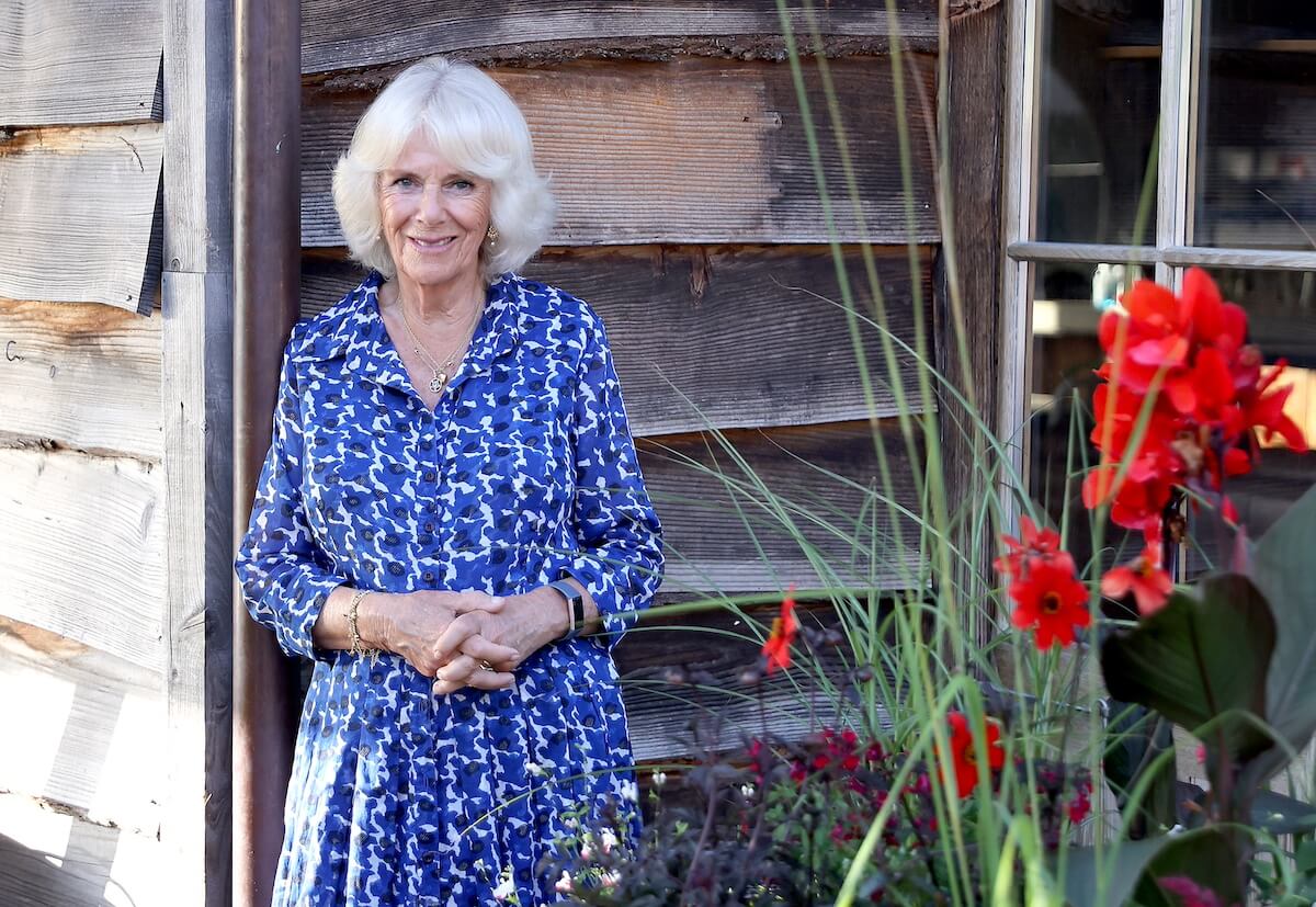 Camilla Parker Bowles standing outside near plants