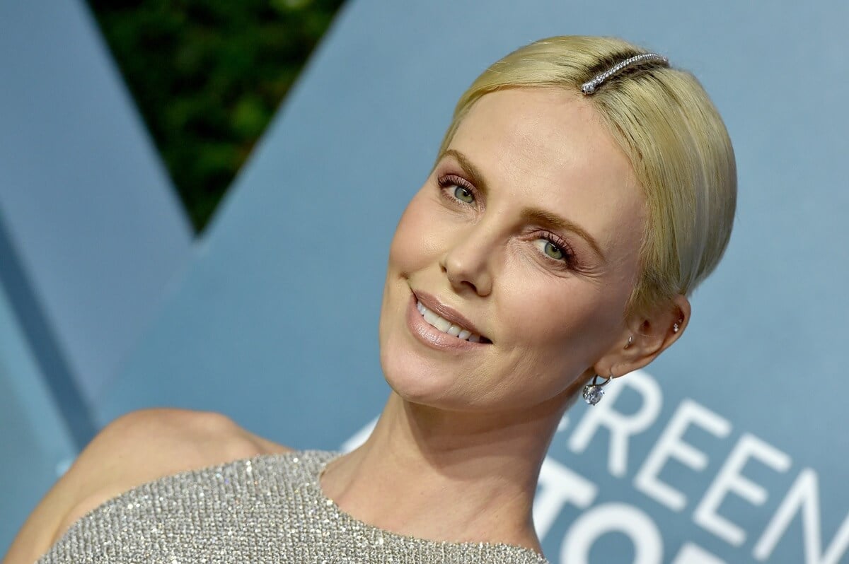 Charlize Theron posing in a silver dress at the 26th Annual Screen Actors Guild Awards.