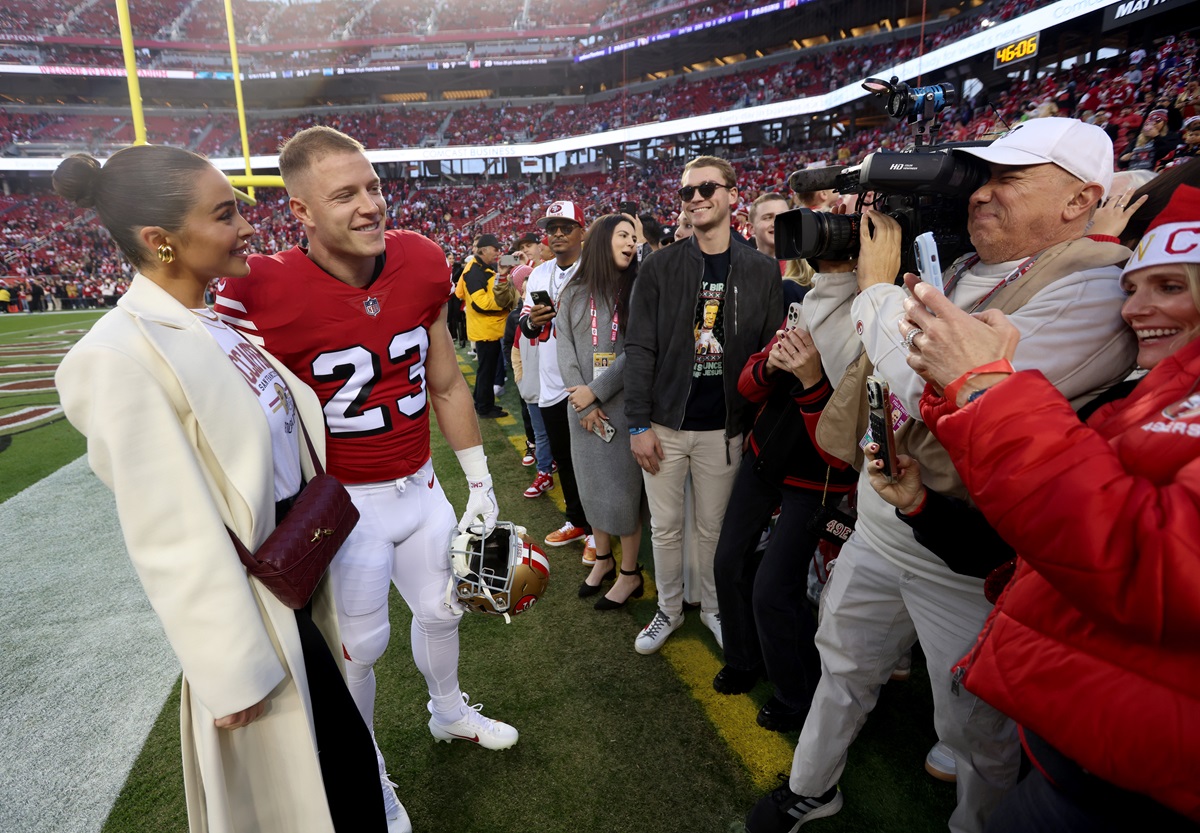 San Francisco 49ers' Christian McCaffrey #23 and his fiancé Olivia Culpo greet fans