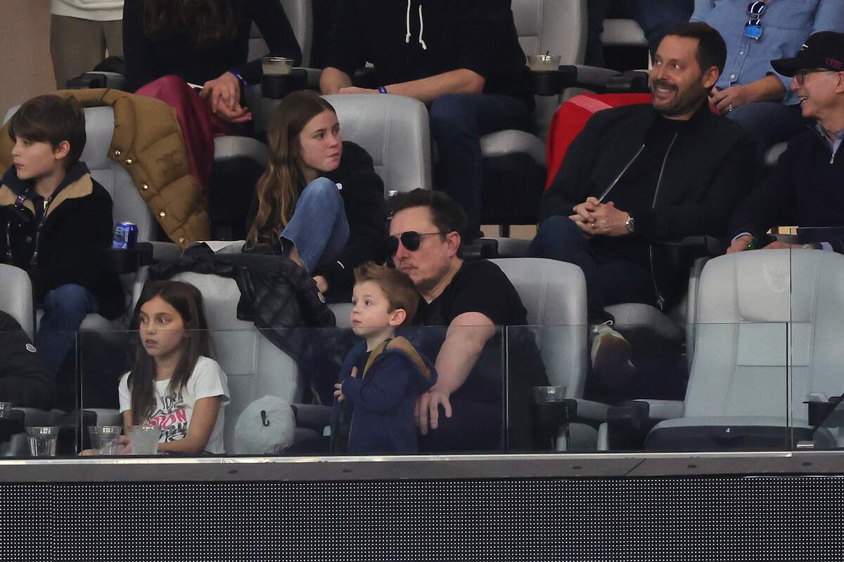 CEO of Tesla Elon Musk looks on in the first half during Super Bowl LVIII while wearing sunglasses and a black tee shirt