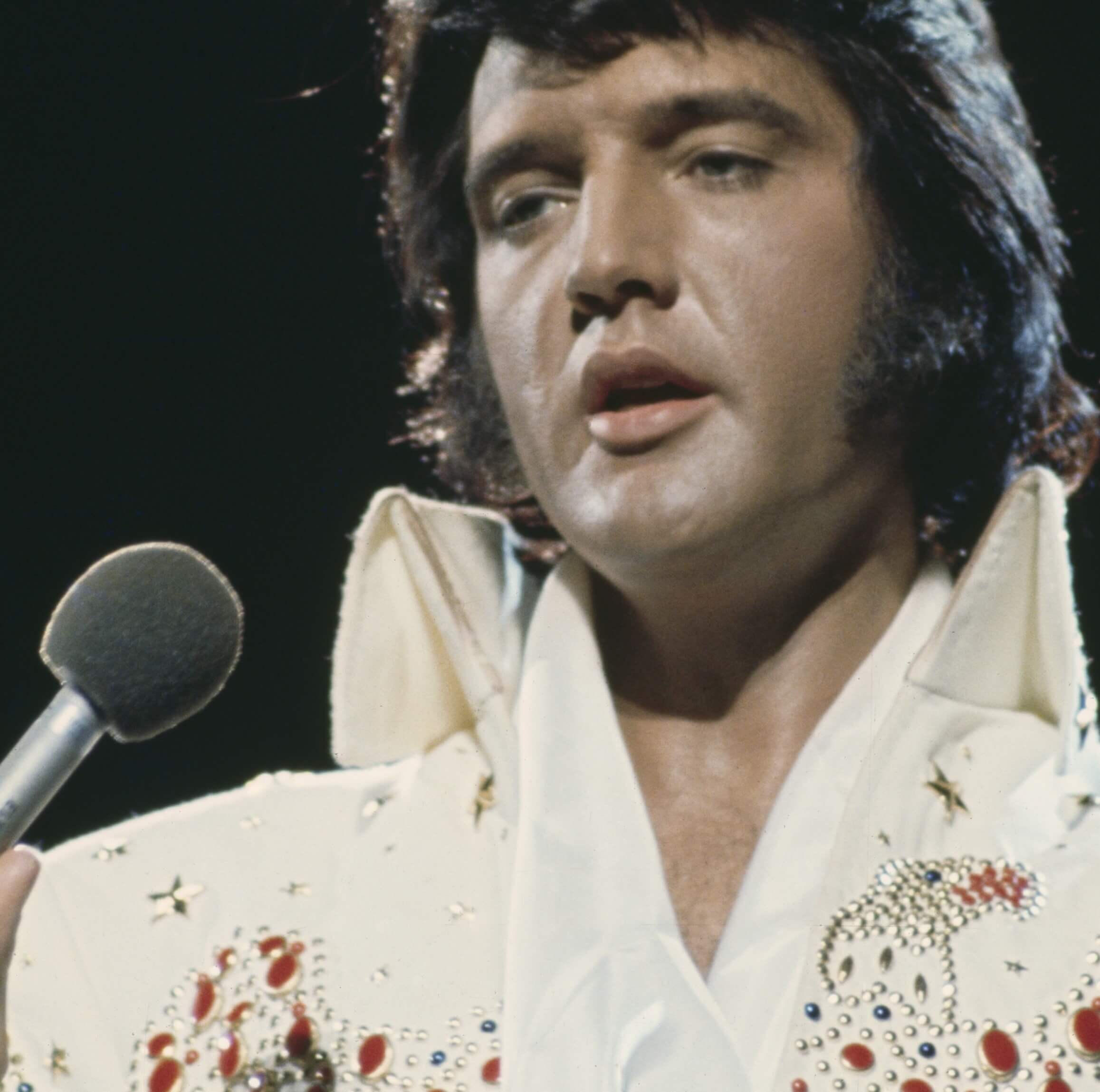 "Rubberneckin'" singer Elvis Presley wearing white