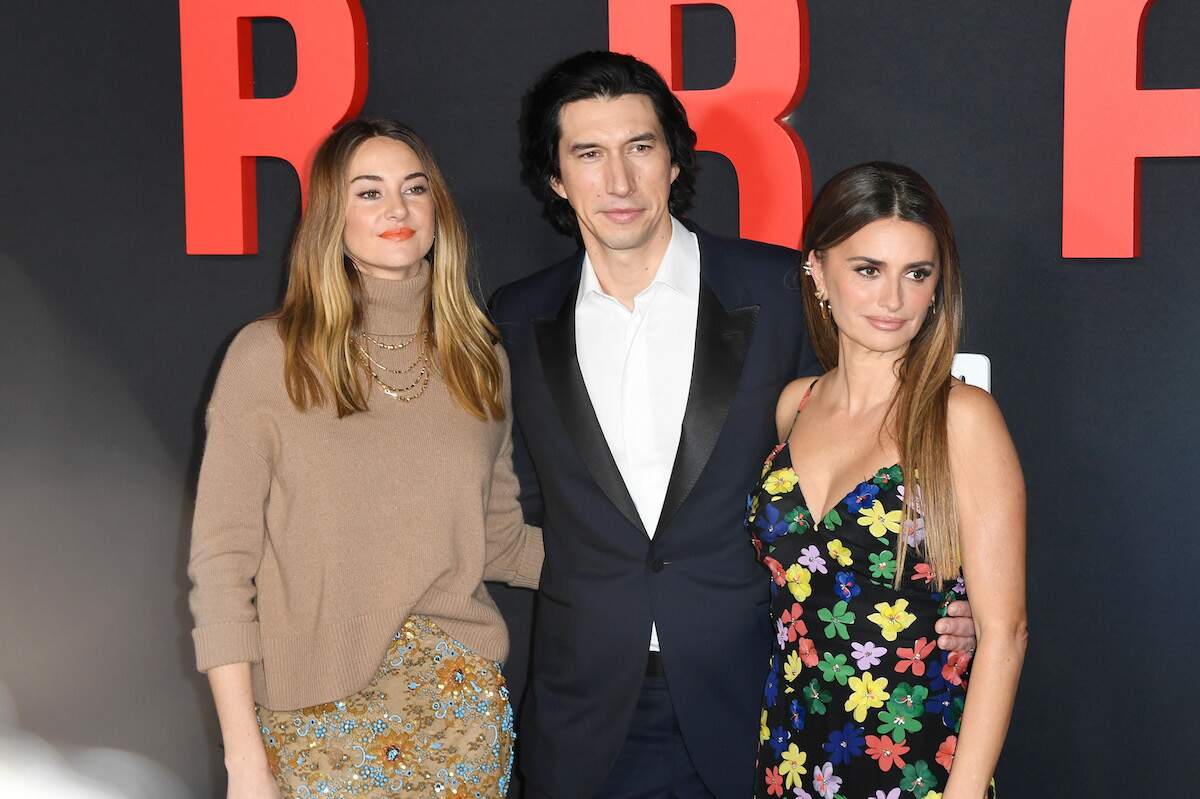 Actors Shailene Woodley, Adam Driver, and Penélope Cruz stand on the red carpet arm in arm