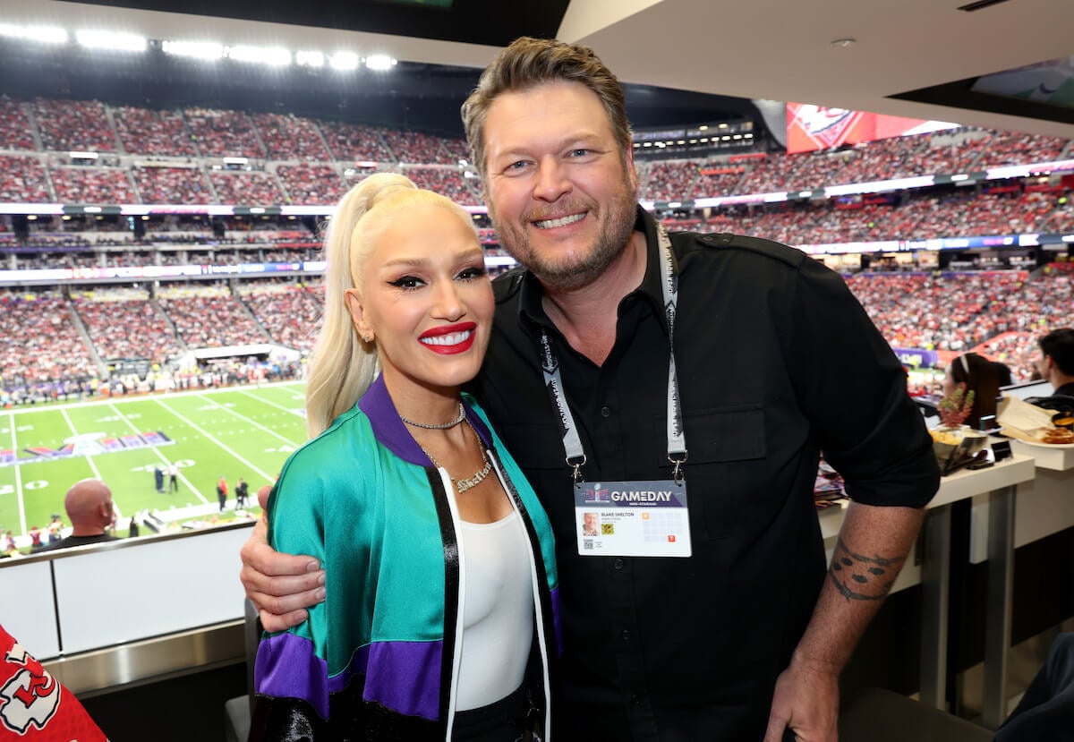 Gwen Stefani and Blake Shelton embracing at the Super Bowl LVIII pregame