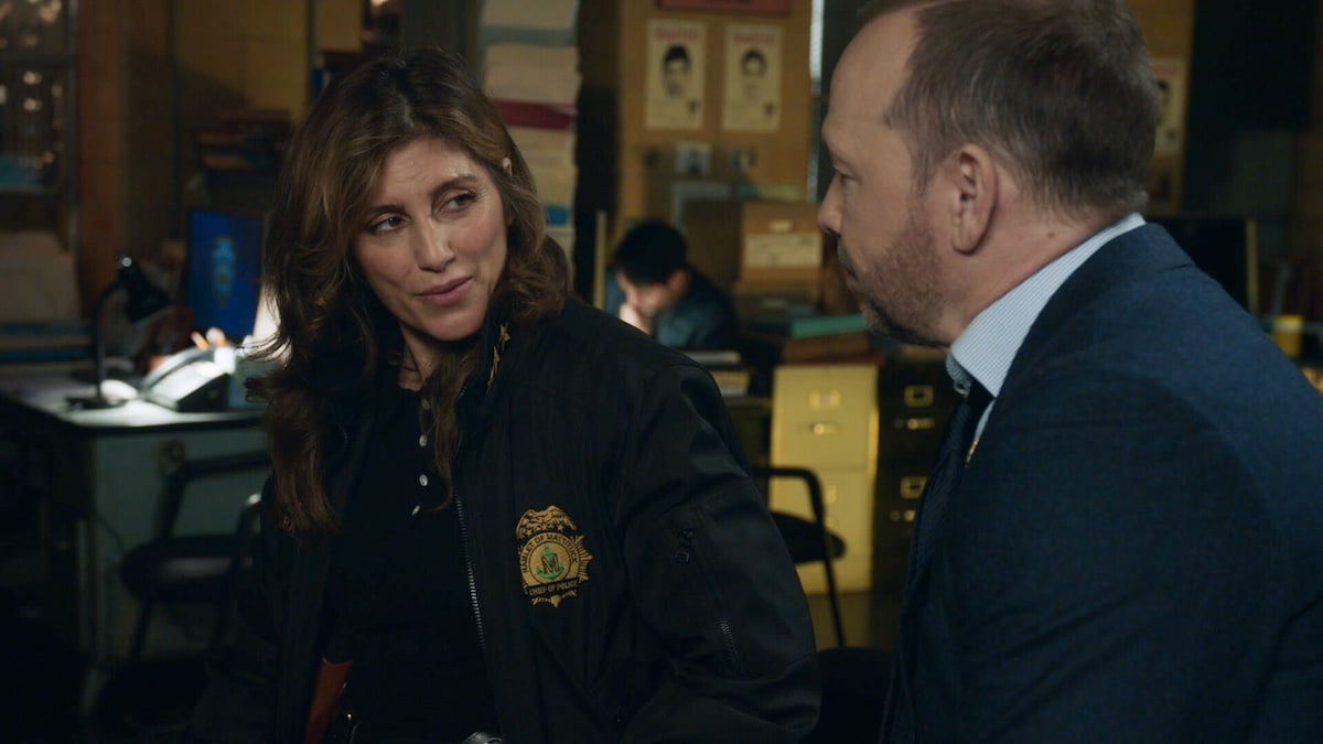 Jennifer Esposito in a sheriff's jacket looking at Donnie Wahlberg in 'Blue Bloods' Season 14 Episode 2