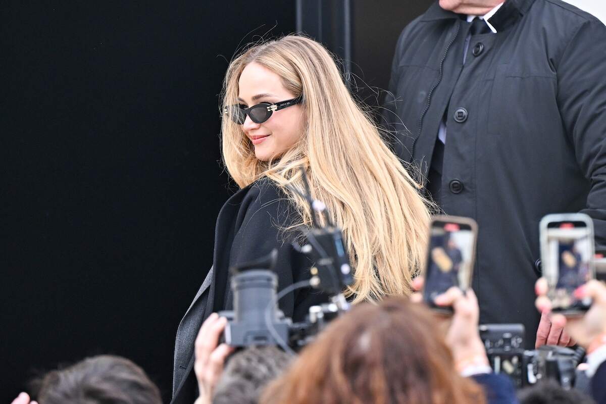 Actress Jennifer Lawrence wears a business-inspired black and gray outfit while walking to the Christian Dior fashion show in Paris, France