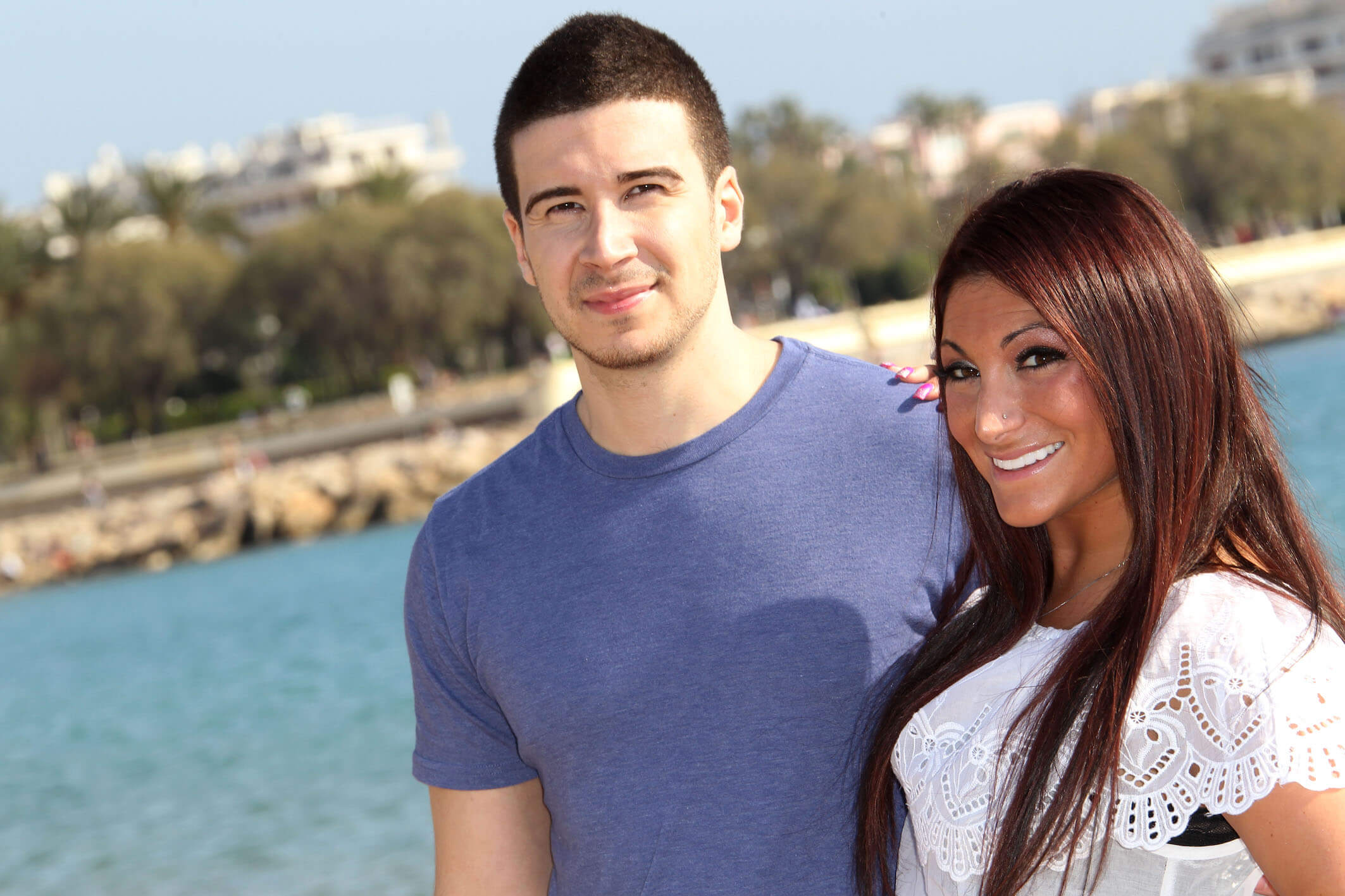 'Jersey Shore: Family Vacation' Season 7 cast members Deena Nicole Cortese and Vinny Guadagnino smiling next to each other while posing outside in 2012