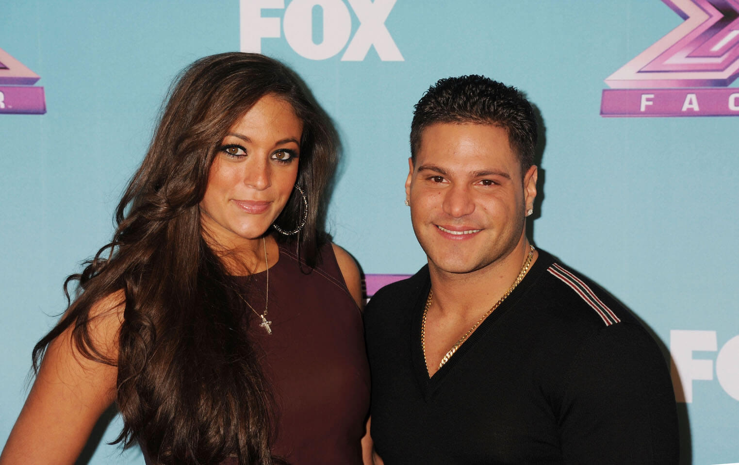 'Jersey Shore' cast members Sammi 'Sweetheart' Giancola and Ronnie Ortiz-Magro posing at a Fox event against a blue background