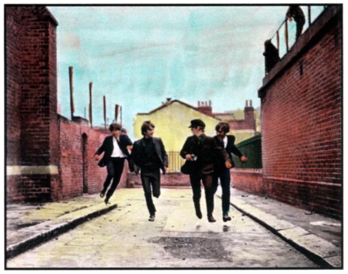 Paul McCartney, George Harrison, Ringo Starr, and John Lennon run down an alley on the poster for 'A Hard Day's Night.'