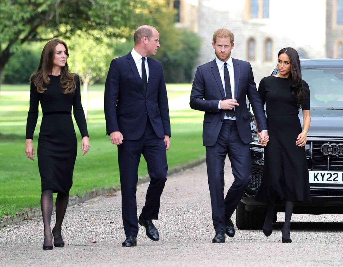 Kate Middleton, Prince William, Prince Harry, and Meghan Markle on the Long Walk at Windsor Castle to view flowers and tributes to Queen Elizabeth