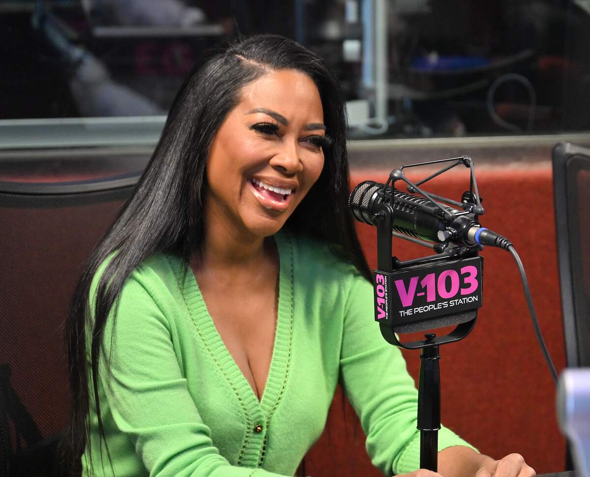 Kenya Moore speaks on an Atlanta radio show on on February 01, 2024 while wearing a bright green cardigan