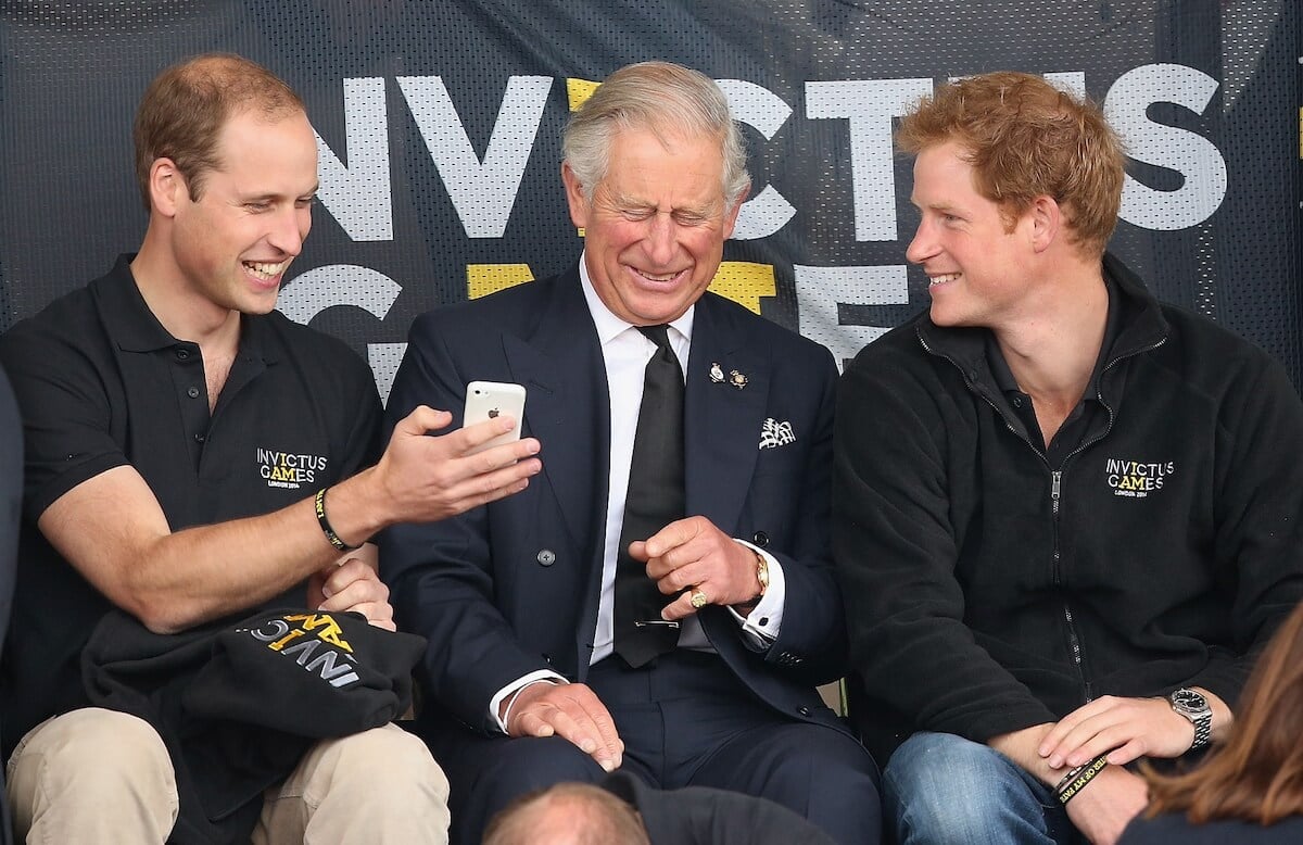 Prince William and Prince Harry laugh with King Charles in 2014