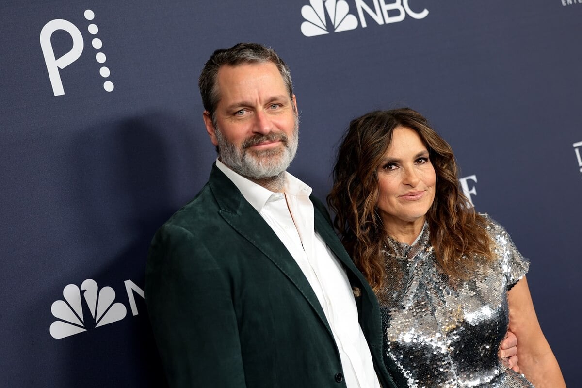 Mariska Hargitay in a silver dress next to her husband Peter Hermann who's wearing a suit.