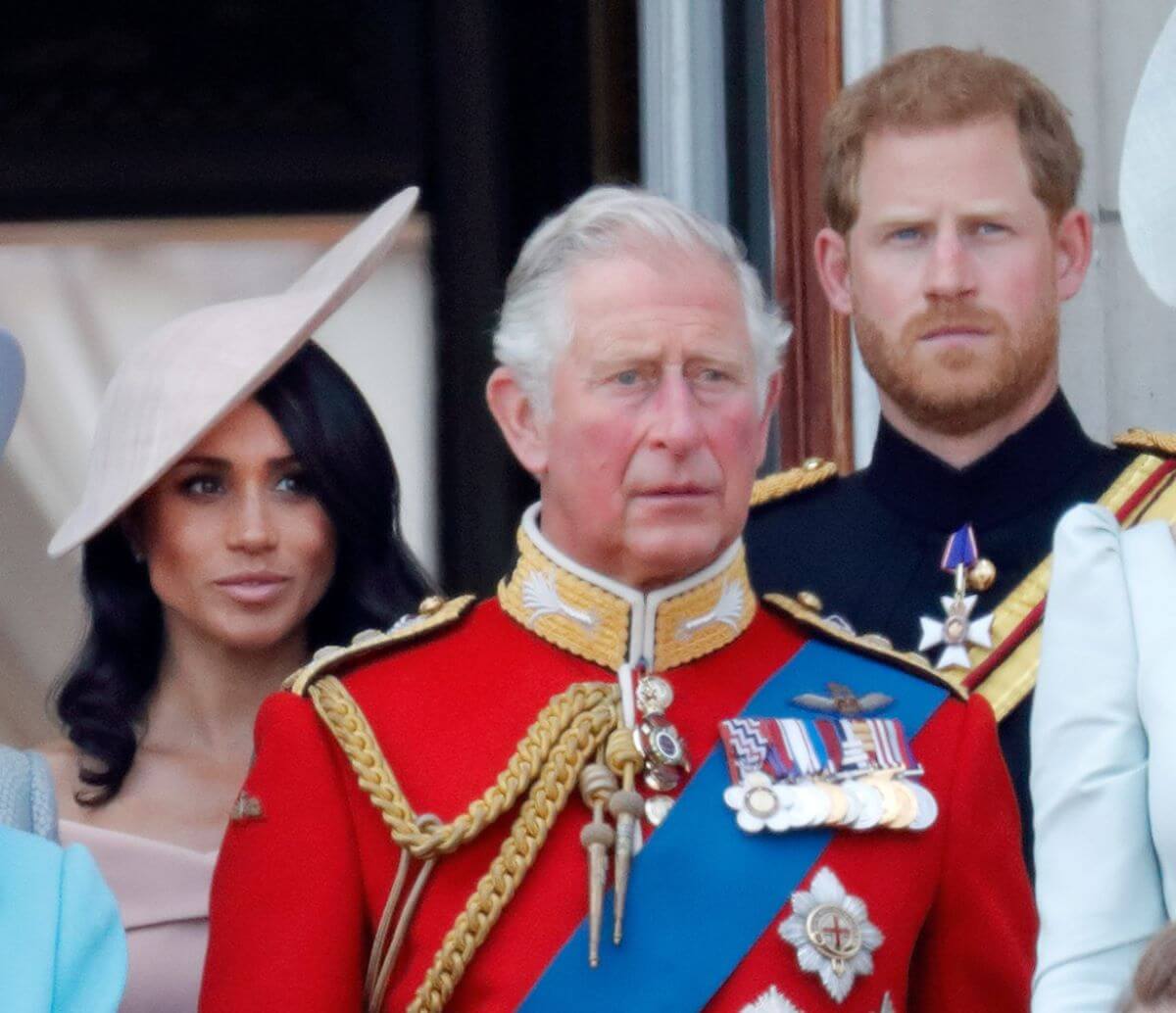 Meghan Markle, Prince Harry and King Charles III standing on the balcony of Buckingham Palace during Trooping The Colour 2018
