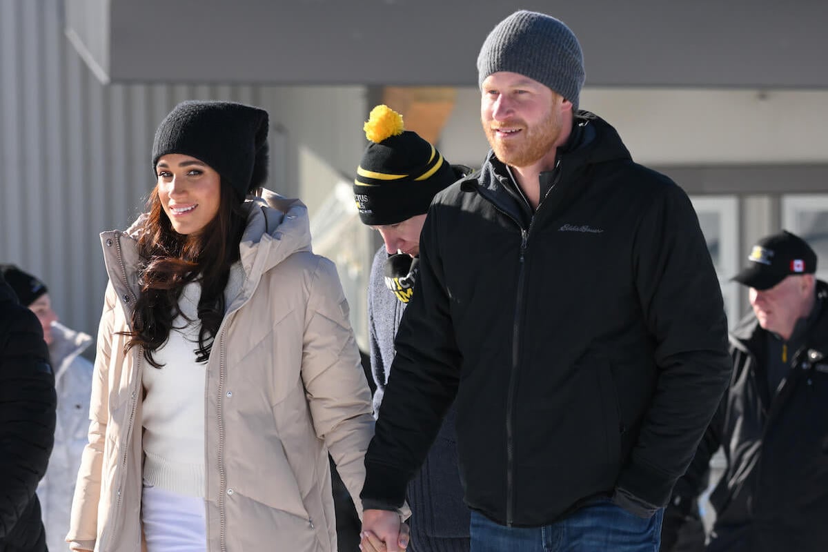Meghan Markle and Prince Harry, who reportedly wants Prince Archie and Princess Lilibet to visit the U.K. more, hold hands