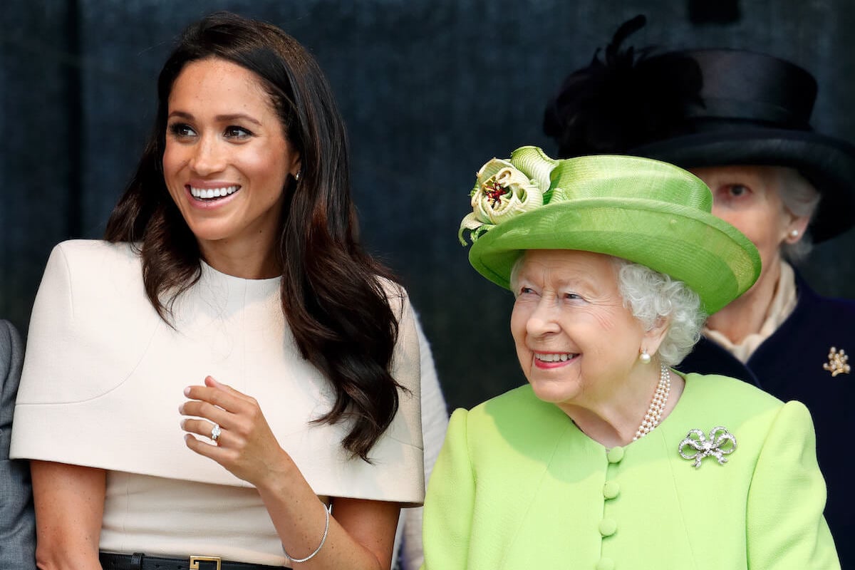 Meghan Markle, who reportedly knew 'exactly how to butter up' the queen, stands next to Queen Elizabeth II