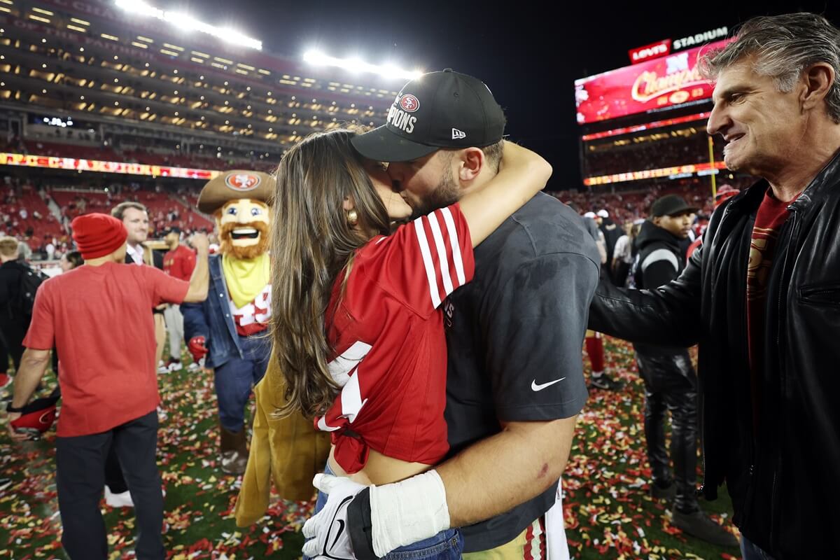 Nick Bosa of the San Francisco 49ers kisses his girlfriend Lauren Maenner after winning the NFC Championship Game