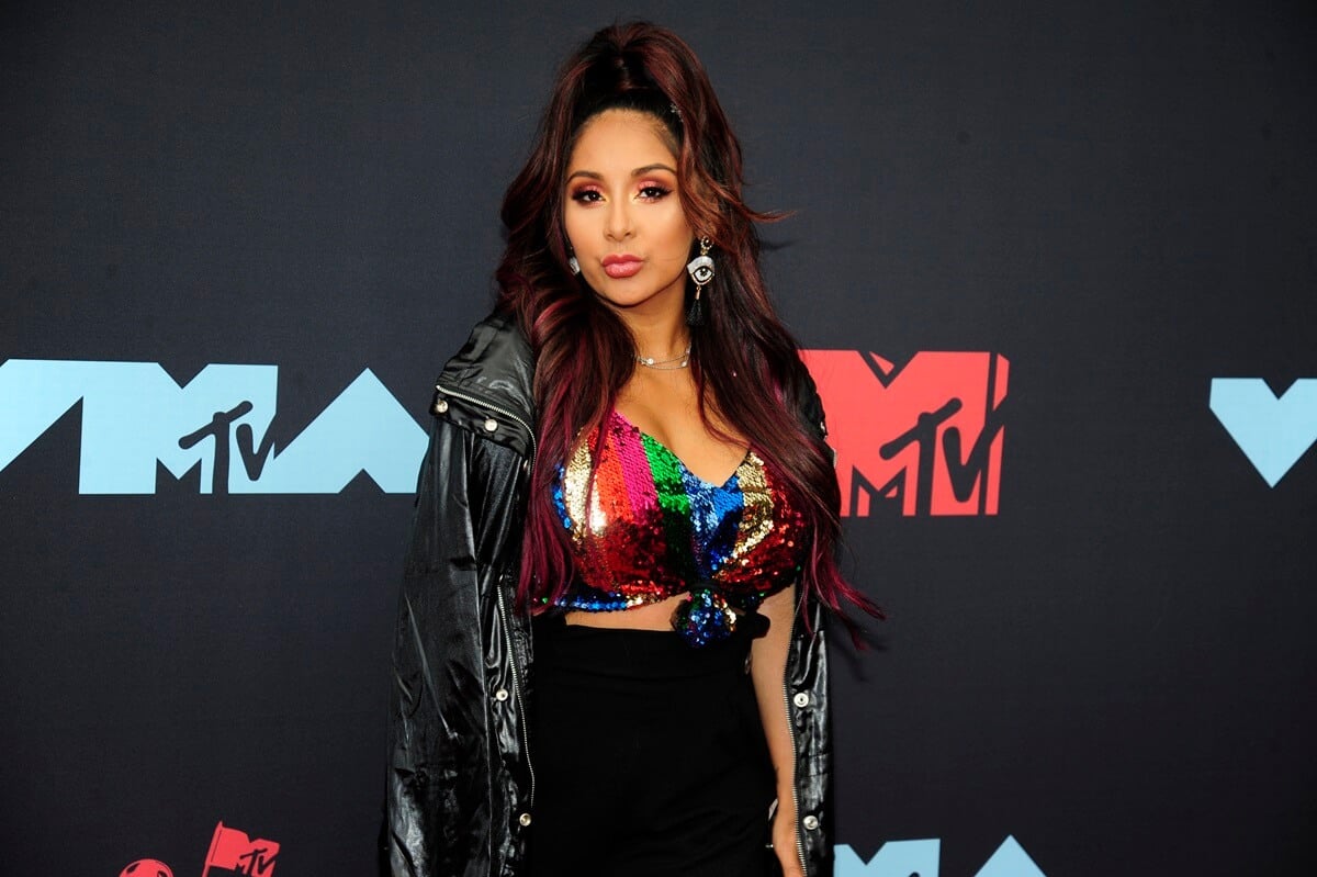 Nicole Snooki Polizzi posing in a black jacket and colorful top at the 2019 MTV Video Music Awards.