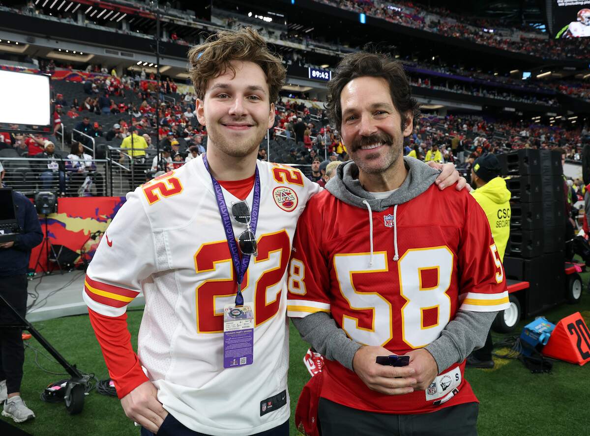 Jack Sullivan Rudd and Paul Rudd smile together on the Chiefs sideline before Super Bowl LVIII