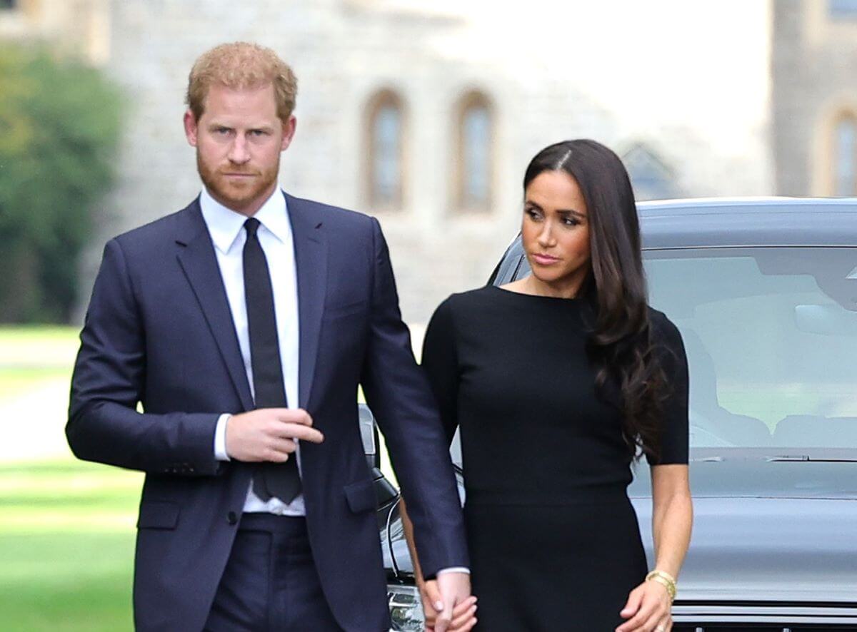 Prince Harry and Meghan Markle on the long Walk at Windsor Castle arrive to view flowers and tributes t Queen Elizabeth II