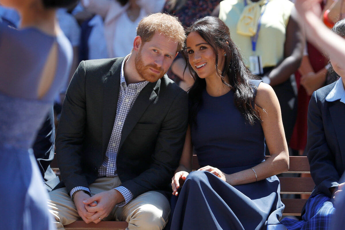 Prince Harry and Meghan Markle, who reportedly have differing views on how to handle the royal family rift, look on