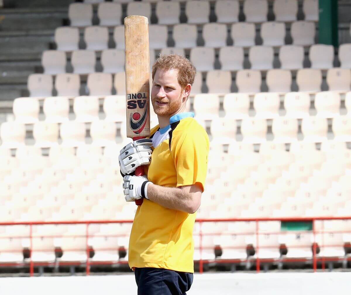 Prince Harry warms up for a cricket match at the Darren Sammy Cricket Ground during visit to Saint Lucia