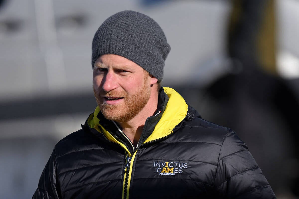 Prince Harry, who reportedly wants to mark the 10-year anniversary of the Invictus Games in the U.K. with Meghan Markle and their children, looks on wearing a hat
