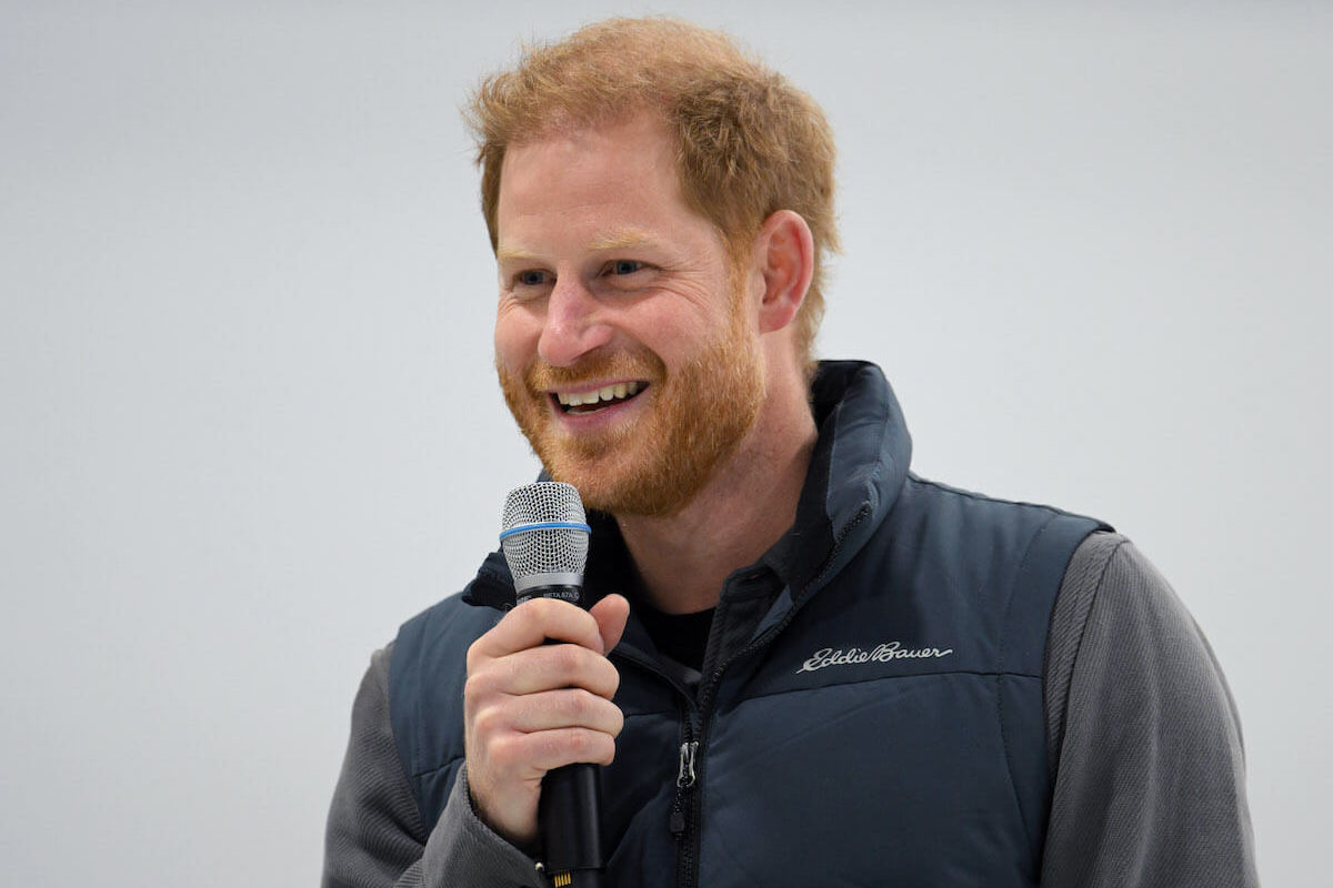 Prince Harry, whose path to U.S. citizenship may make him part of an 'underdog story,' at the Invictus Games One Year to Go celebrations, smiles and speaks into a microphone
