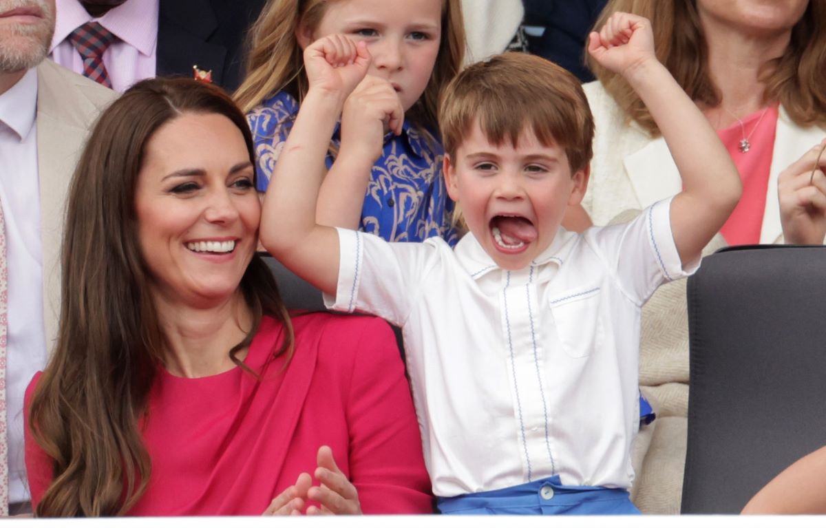 Prince Louis raising his arms in the air next to mom Kate Middleton during the Platinum Pageant