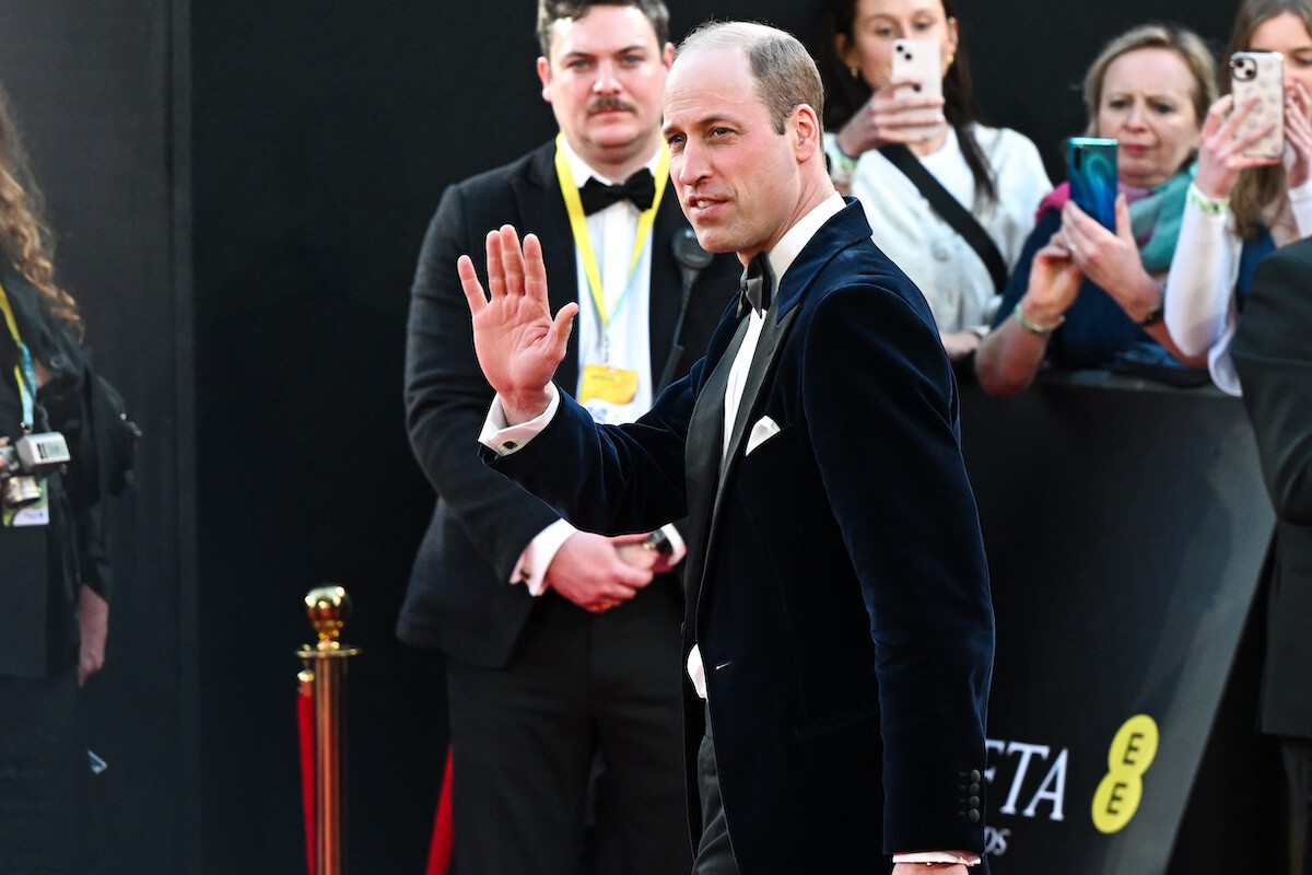 Prince William waves wearing a tuxedo arriving at the 2024 BAFTAs without Kate Middleton.