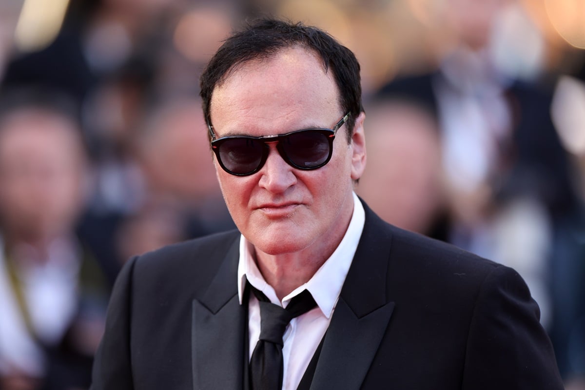 Quentin Tarantino posing in a suit and shades at the "Elemental" screening and closing ceremony red carpet during the 76th annual Cannes film
