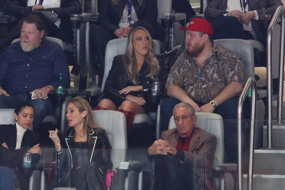 Luke Combs and wife Nicole Hocking sit together in the stands at Super Bowl LVIII
